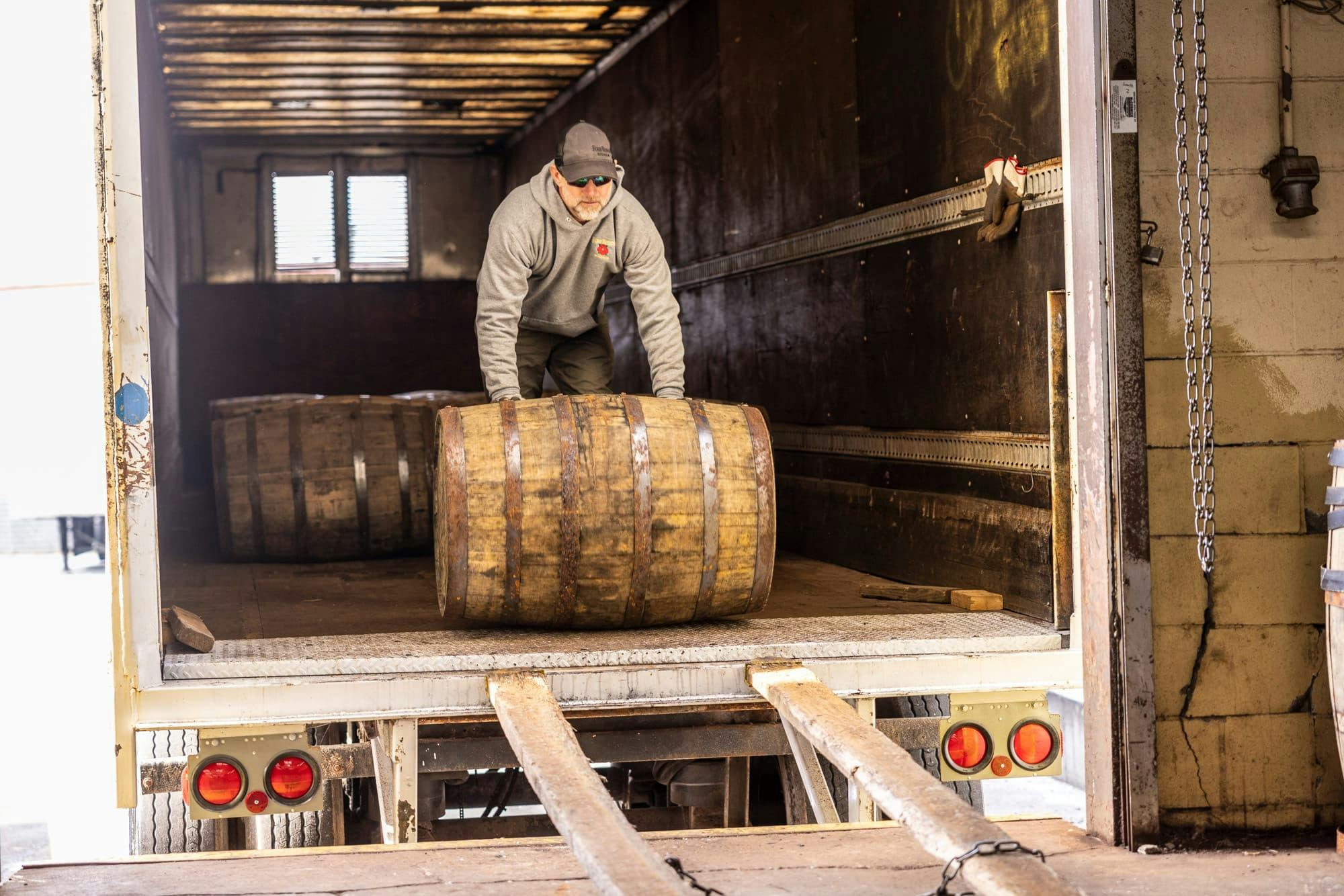 A Four Roses team member unload barrels from a truck for warehousing.